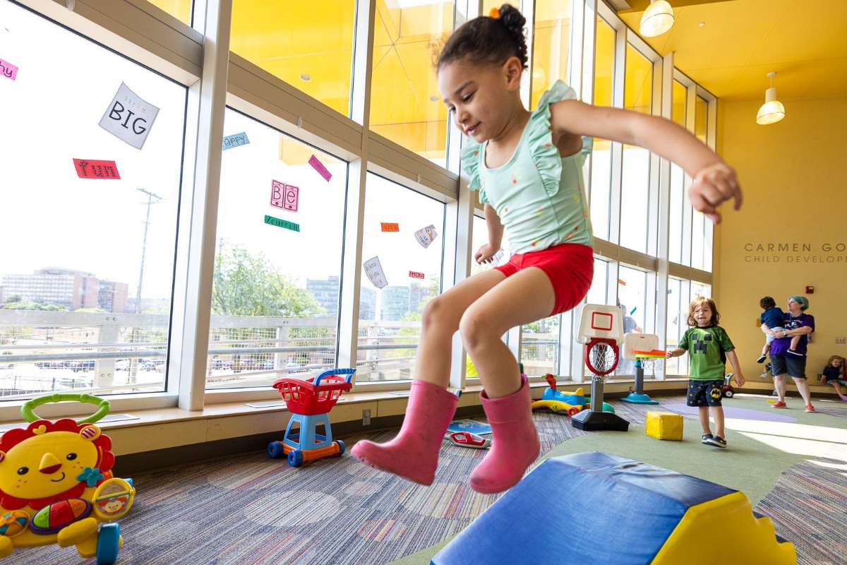 Child jumping over obstacle