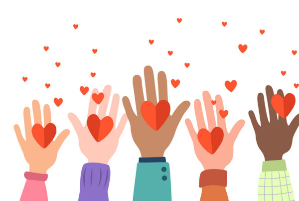 Multiple hands extending with hearts to represent a spread of love.
