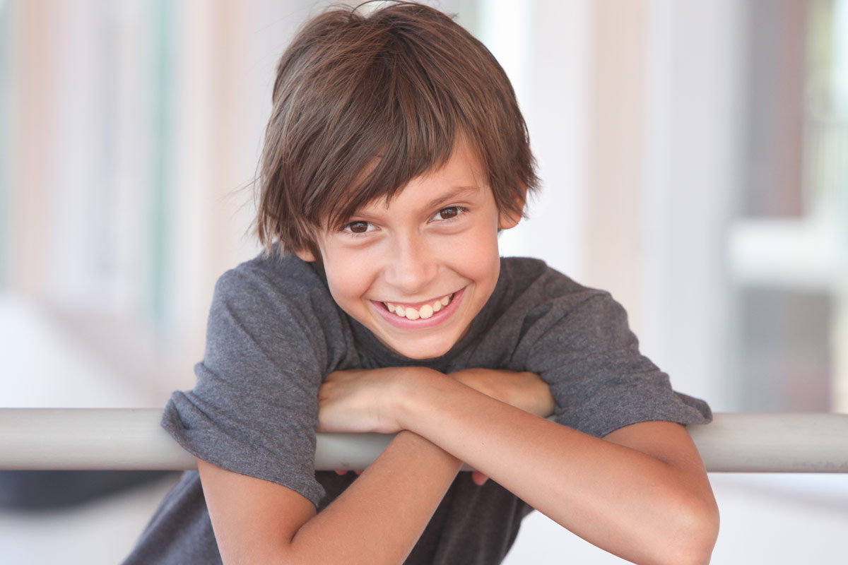 Happy Boy Leaning on Rail